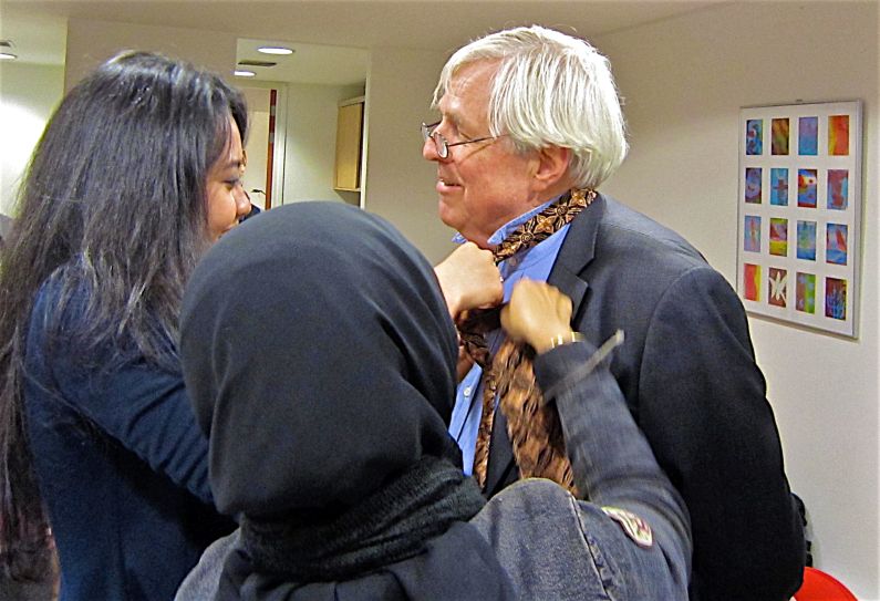 The Hague 2011 Two Sekretariat parcipants knotting their gift around Jan Janus' neck